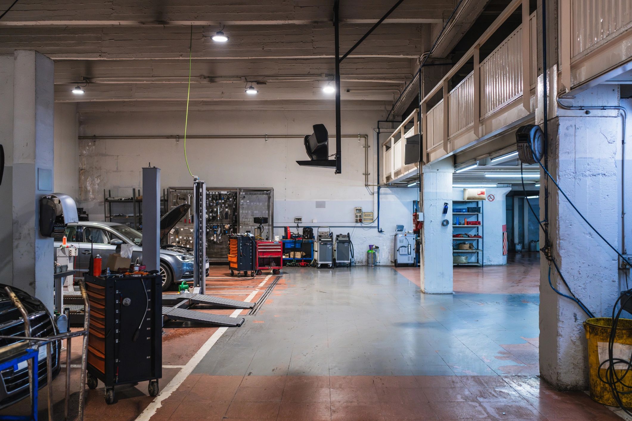 Auto repair shop service bay with lifts and toolboxes